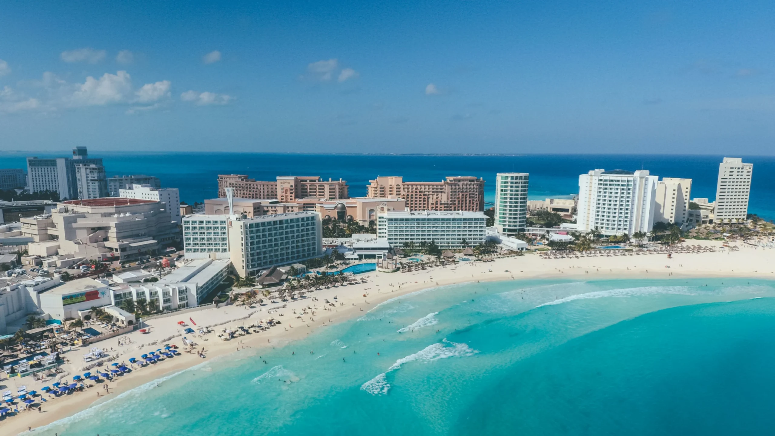 Aerial view of Cancun beachfront hotels and turquoise Caribbean water